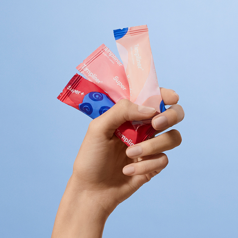 A hand holding a wrapped Tampliner